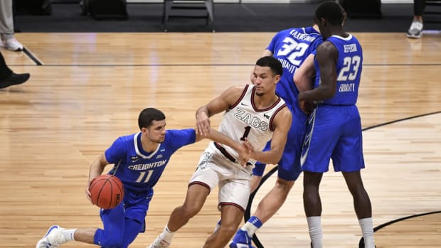 Mar 28, 2021; Indianapolis, IN, USA; Creighton Bluejays guard Marcus Zegarowski (11) dribbles the ball against Gonzaga Bulldogs guard Jalen Suggs (1) as Creighton center Ryan Kalkbrenner (32) and forward Damien Jefferson (23) move around the top of the key in the second half during the Sweet 16 of the 2021 NCAA Tournament at Hinkle Fieldhouse. Mandatory Credit: Doug McSchooler-USA TODAY Sports